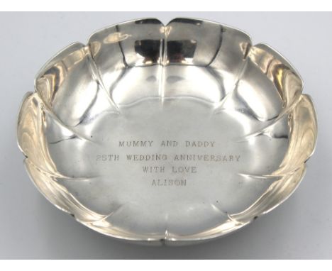 An Elizabeth II silver small bowl, of floral shape with gadrooned type circular foot, engraved to centre of bowl "Mummy and D