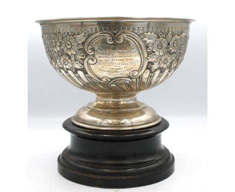 An Edwardian silver rose bowl, elaborately embossed with flowers, foliage and scrolled design, engraved presentation inscript