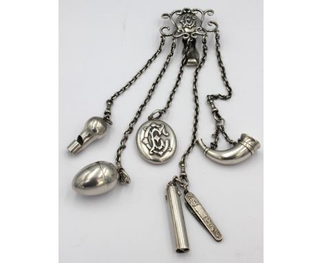 A Victorian white metal chatelaine (unmarked), having clip with scrolled work surrounding oval initialled cartouche "EC", wit