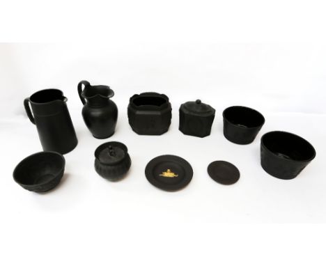 A collection of Wedgwood black basalt ceramics comprising: a tea caddy, two jugs, three sugar bowls, a pot and cover, and two