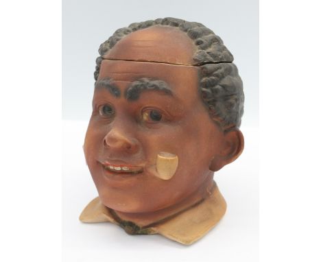 An early 20th Century ceramic tobacco jar in the style of a black man.