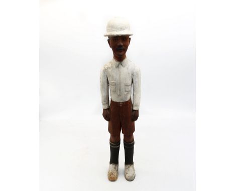 An early 20th century Colonial carved wooden figure of probably Captain Charles Couldrey of The Royal Field Artillery, wearin