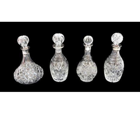 Four similar 20th century cut glass decanters with silver collars, all Elizabeth II silver with Birmingham hallmarks, various