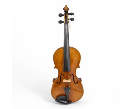  A cased violin with bow, copy of a Stradivarius, in good condition.