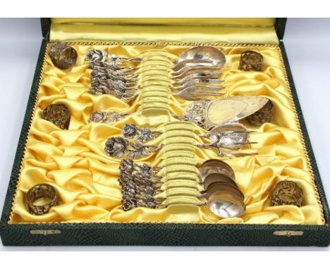 A mid 20th century Continental 835 silver part cutlery set consisting of six small cylindrical napkin rings with foliate deco