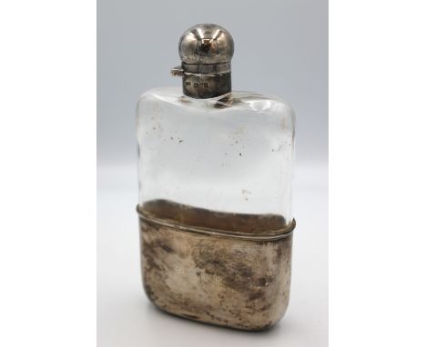 An Edwardian silver and glass hip flask, with removable curved cup with gilt interior and engraved initials "P.S.C.M", hallma