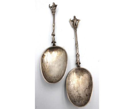 A near pair of late 19th century Dutch silver presentation spoons, both with large egg shaped bowls, engraved decorative stem
