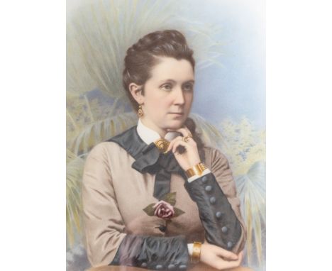 An early 20th century painted porcelain portrait plaque depicting an Edwardian lady surrounded  by foliage, signed lower left