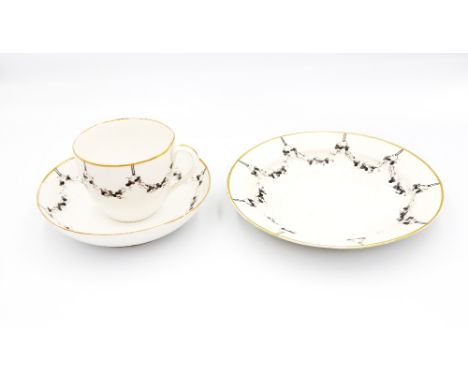 A Pinxton porcelain trio, tea cup, saucer and side plate, decorated with a black hanging swag border, circa late 18th century
