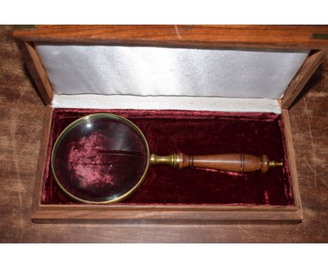 Magnifying glass 10cm dia with brass surround, in wooden case 27 x 13 x 5cm.