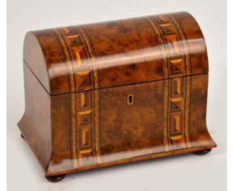 A Victorian walnut and strap bound inlaid decorated dome topped two division tea caddy raised on squat bun feet, width 23cm.