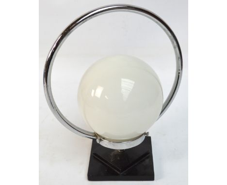 An Art Deco style chrome table lamp with opaque globular shade.