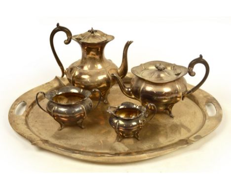 A George V hallmarked silver four piece tea service and matching tray of lobed form with pronounced rim, John Round & Son, Sh