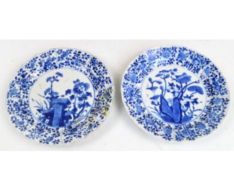 A pair of Chinese porcelain plates painted in underglaze blue with floral sprays and bearing Kangxi mark to the reverse, diam