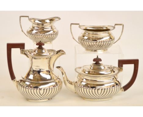 A George VI hallmarked silver four piece tea service with gadrooned body and rim, maker mark obscured, Birmingham 1948, combi
