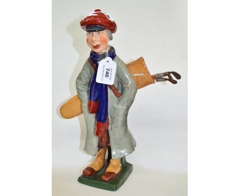 A 19th century Amphora ware ceramic figural pencil holder, modelled as a golfer with a bag on his back housing pencils with g