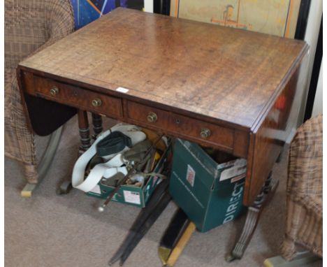 A late George III mahogany sofa table with twin rounded flaps, twin ring turned end columns to fluted square section outswept
