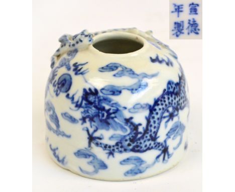 A 19th century Chinese porcelain beehive water pot, painted in underglaze blue with two confronting dragons on a ground of fl