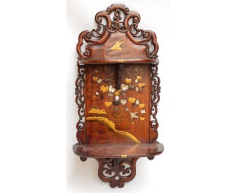 A 19th century Japanese hardwood wall shelf with Shibayama type central panel, lacquered and mother of pearl inlaid with bird