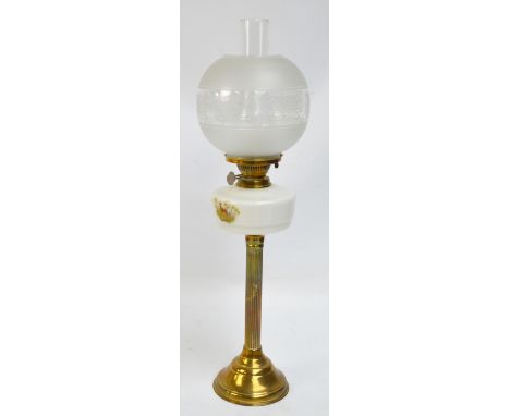 A brass oil lamp with etched globular shade, opaque reservoir and fluted central column, height including chimney 72cm.
