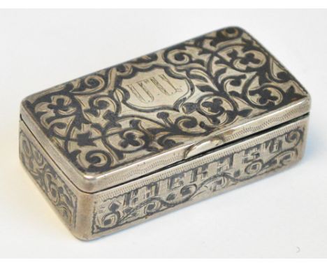 An early 20th century Russian silver snuff box with overall foliate niello decoration, centred with a shield shaped cartouche