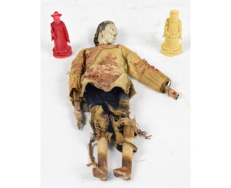 An 18th century Chinese doll with composition head, silk embroidered robe and wooden limbs, height 26cm (badly af) and two iv