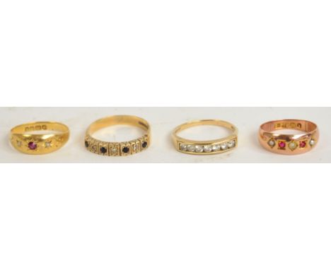 An 18ct yellow gold dress ring set with a ruby and two emerald chips, size J/K, and three other 9ct gold dress rings, one set