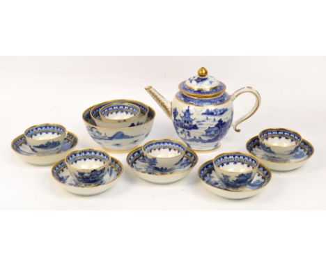 An early 19th century Export Chinese porcelain tea service, hand painted in blue and white with landscapes and heightened in 