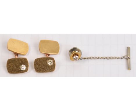 A pair of 9ct gold cufflinks, each with textured top platform set with a diamond, with a diamond set tie pin, cufflink weight