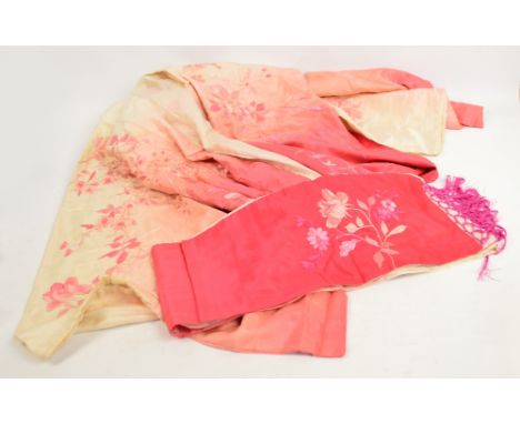 A Chinese pink and cream floral embroidered jacket with belt sash.