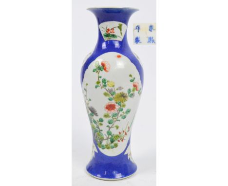 A 19th century Chinese porcelain baluster vase, painted in Famille Rose enamels with panels of chrysanthemum and peony sprays