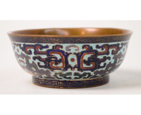 An unusual early 20th century Chinese enamel on copper bowl of ogee form, decorated with archaic motifs within a Greek key bo