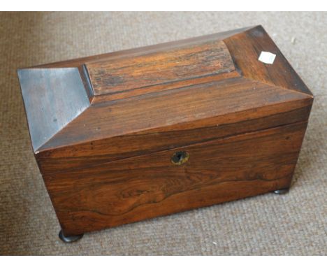 A Victorian rosewood sarcophagus shaped tea caddy with two leaded sections and a glass mixing bowl (af), width 30cm.