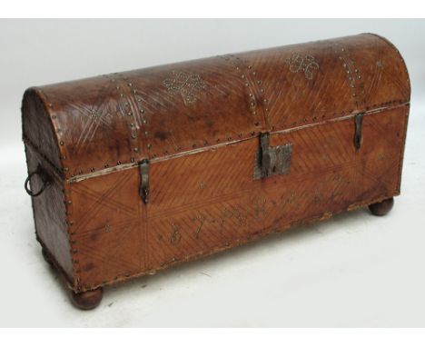 An early 19th century European leather and brass studded dome topped trunk with hinged lid, width 114.5cm, height 58.5cm.