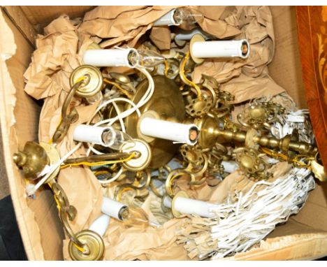 A brass Warsaw style brass electrolier with central turned columns supporting four upper branches and ten lower scrolling bra