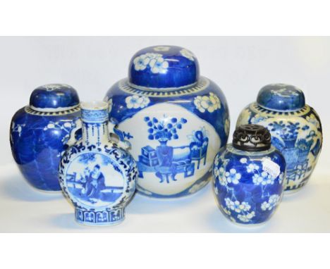 A 19th century Chinese porcelain jar and cover painted in underglaze blue with two quatrilobed panels depicting vase of flowe