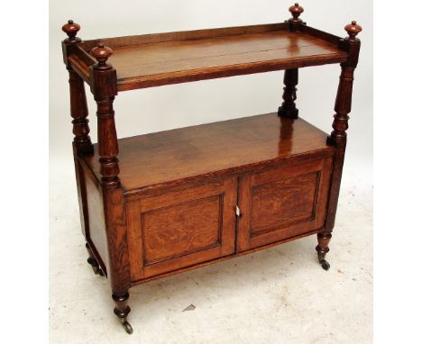 A Victorian oak buffet, the three quarter galleried top above ring turned supports to a twin cupboard door base, ring turned 