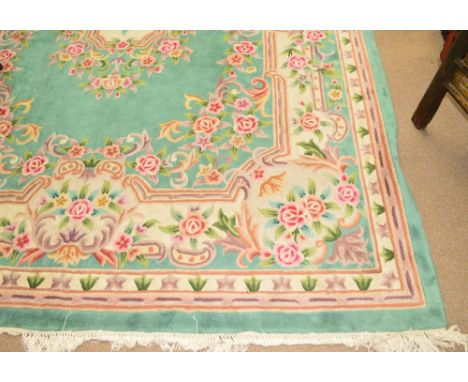A green ground Chinese Superwash carpet, decorated with floral sprays.