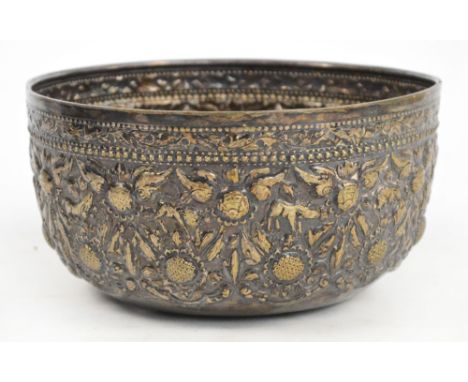 A late 19th/early 20th century Chinese white metal circular bowl with foliate and bead decorated border, chased with animals 