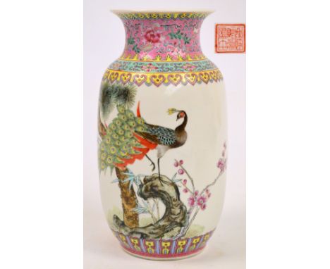 A Chinese Republic porcelain baluster vase, painted with a peacock on a rocky outcrop issuing bamboo and prunus sprays beneat