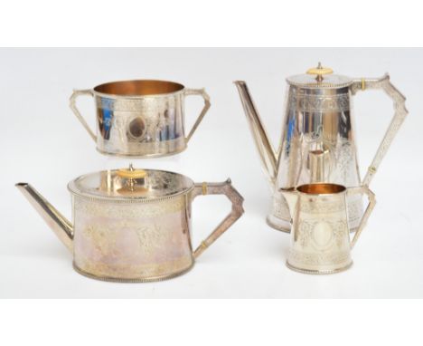 A late Victorian electroplated four piece tea service with engraved foliate scroll decoration comprising a teapot of oval for