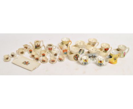 A collection of crested china including miniature shaving mugs, miniature tea service etc.