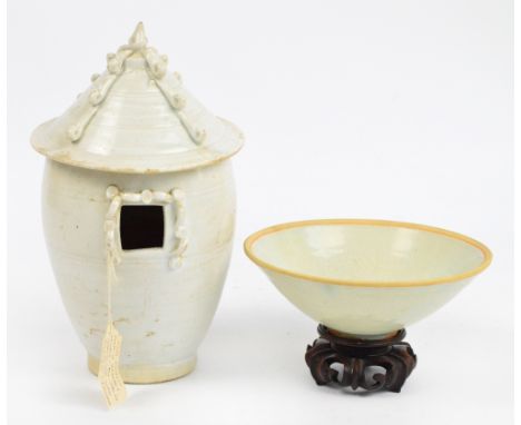 A Chinese porcelain Qingbai Northern Song Dynasty bowl, decorated in relief to the interior with two boys amongst pomegranate