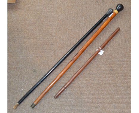 A Scottish malacca shafted walking cane, length 89cm, an ebonised shafted walking cane with mount stamped "Silver", length 90