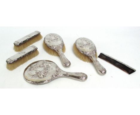 An Edward VII hallmarked silver backed five piece dressing table set comprising hand mirror, two hand brushes and two clothes