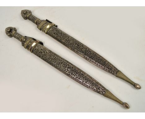 Two 20th century Caucasian kinjals with foliate engraved decorated scabbard, length 53cm.