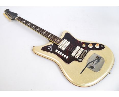 An Eko six string electric guitar with glitter finish, in soft carry case. CONDITION REPORT: The guitar is showing plenty of 