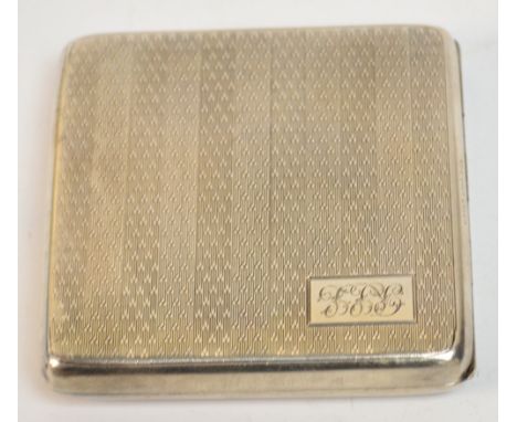 A George V hallmarked silver cigarette case of square form with overall engine turned decoration, with a rectangular cartouch