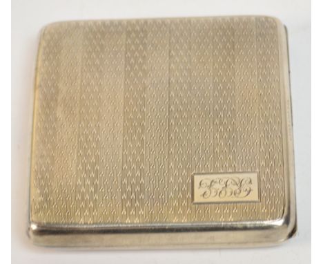 A George V hallmarked silver cigarette case of square form with overall engine turned decoration, with a rectangular cartouch