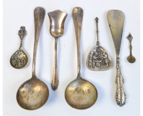 A Dutch white metal spoon with shaped embossed bowl, an embossed white metal caddy spoon, a stainless steel bladed silver she